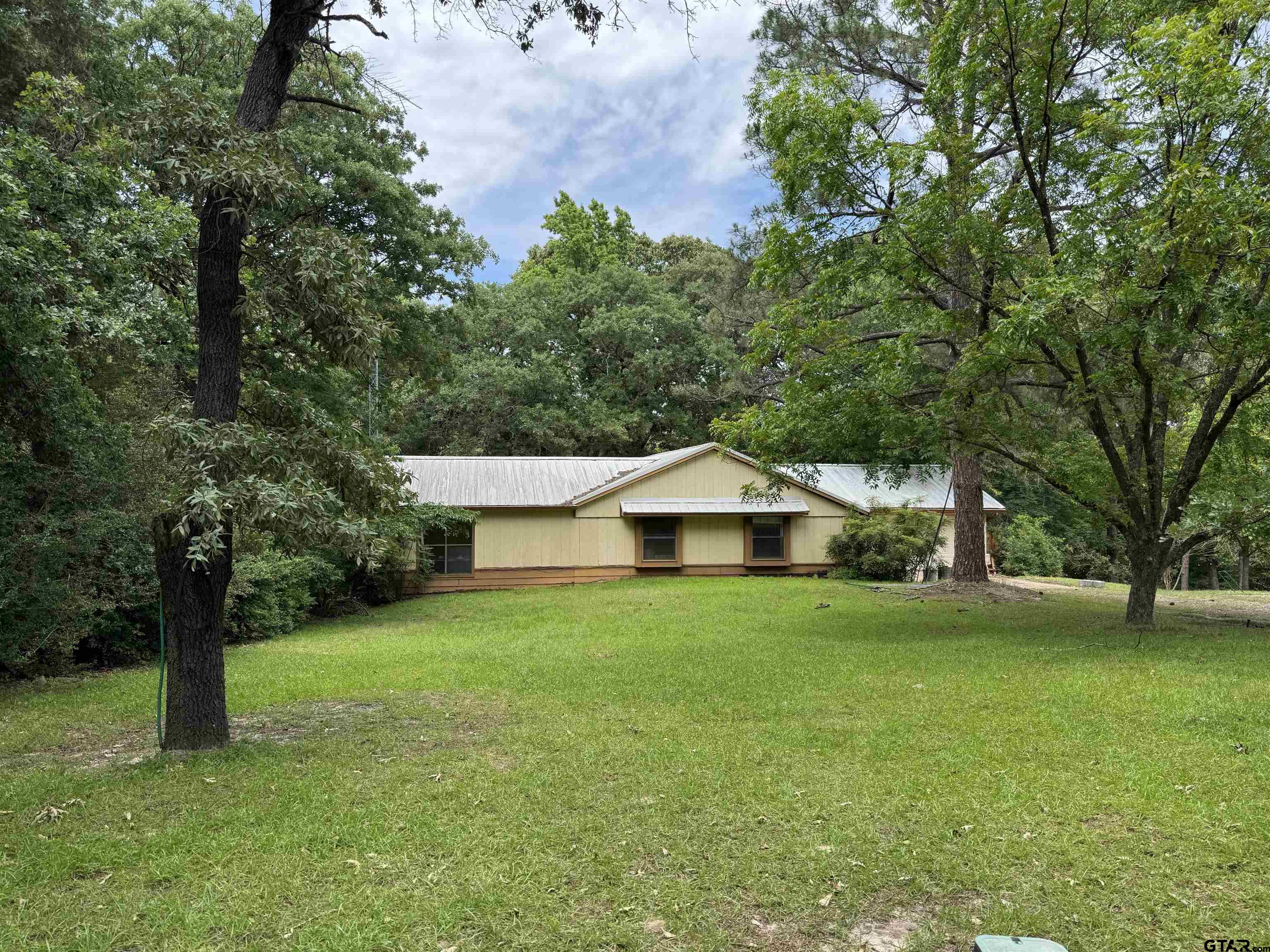 289 Llano Bend Holly Lake Ranch, TX 75765 - Photo 1 of 48 a view of a house with a yard