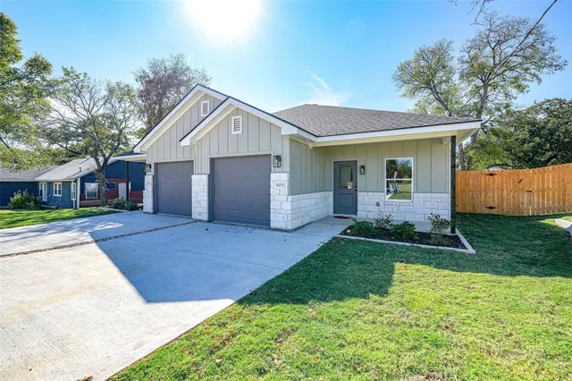 a front view of house with a garden
