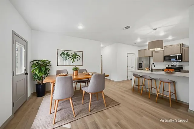 a view of a dining room with furniture and wooden floor