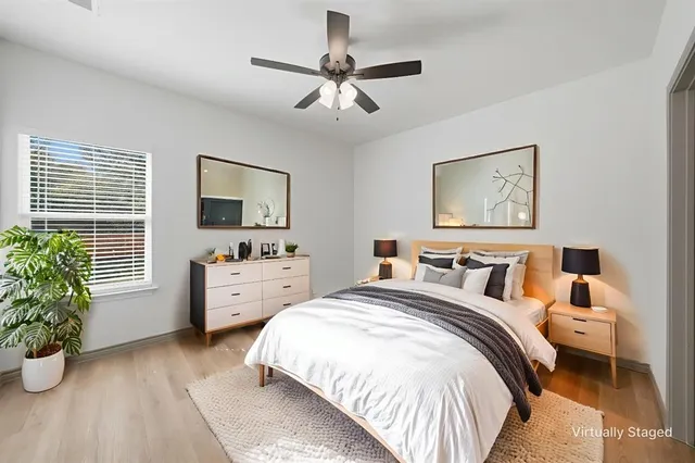 a bedroom with a bed and a potted plant