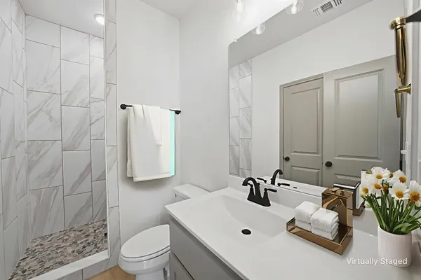 a bathroom with a sink toilet and shower