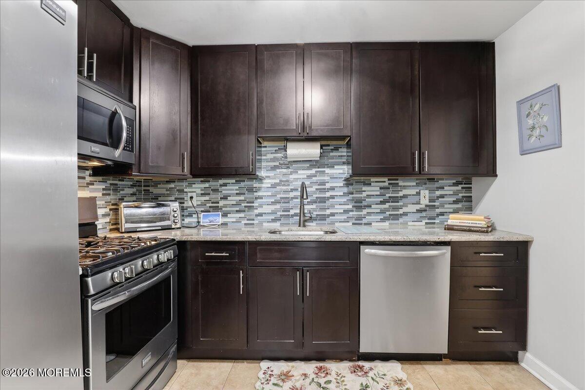 402 Daisy Court Jackson, NJ 08527 - Photo 16 of 44 a kitchen with stainless steel appliances granite countertop a sink stove and cabinets