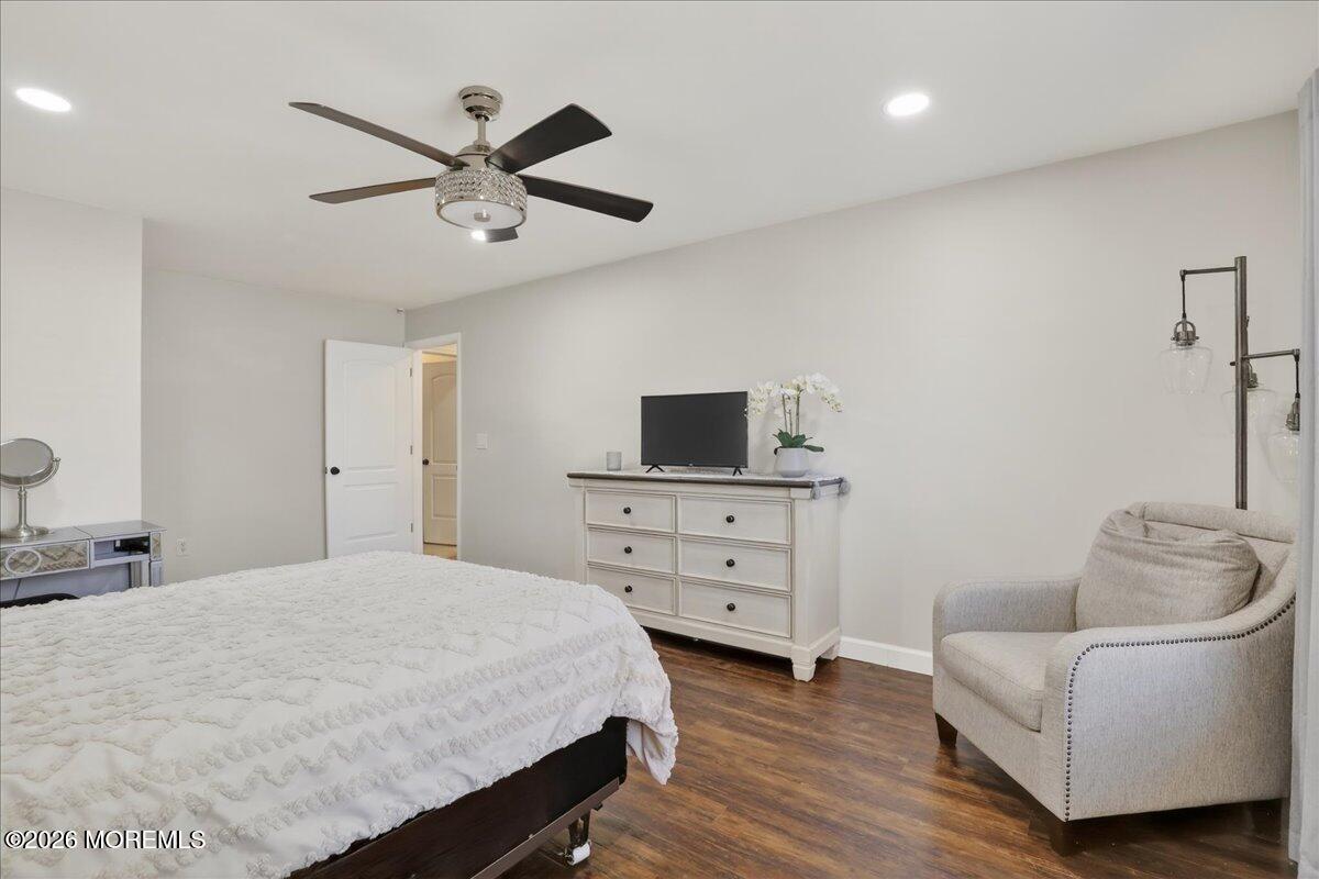 402 Daisy Court Jackson, NJ 08527 - Photo 20 of 44 a bedroom with a bed a couch and a ceiling fan