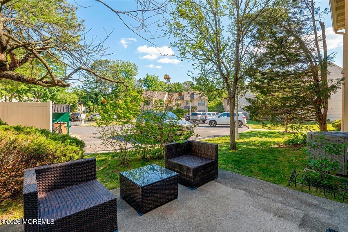 402 Daisy Court Jackson, NJ 08527 - Photo 28 of 44 a view of a chairs and table in the backyard