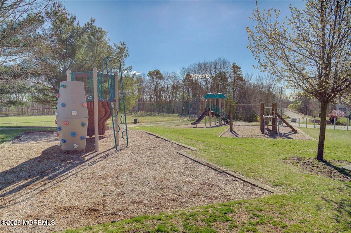 402 Daisy Court Jackson, NJ 08527 - Photo 37 of 44 a view of a park with swings and a slide