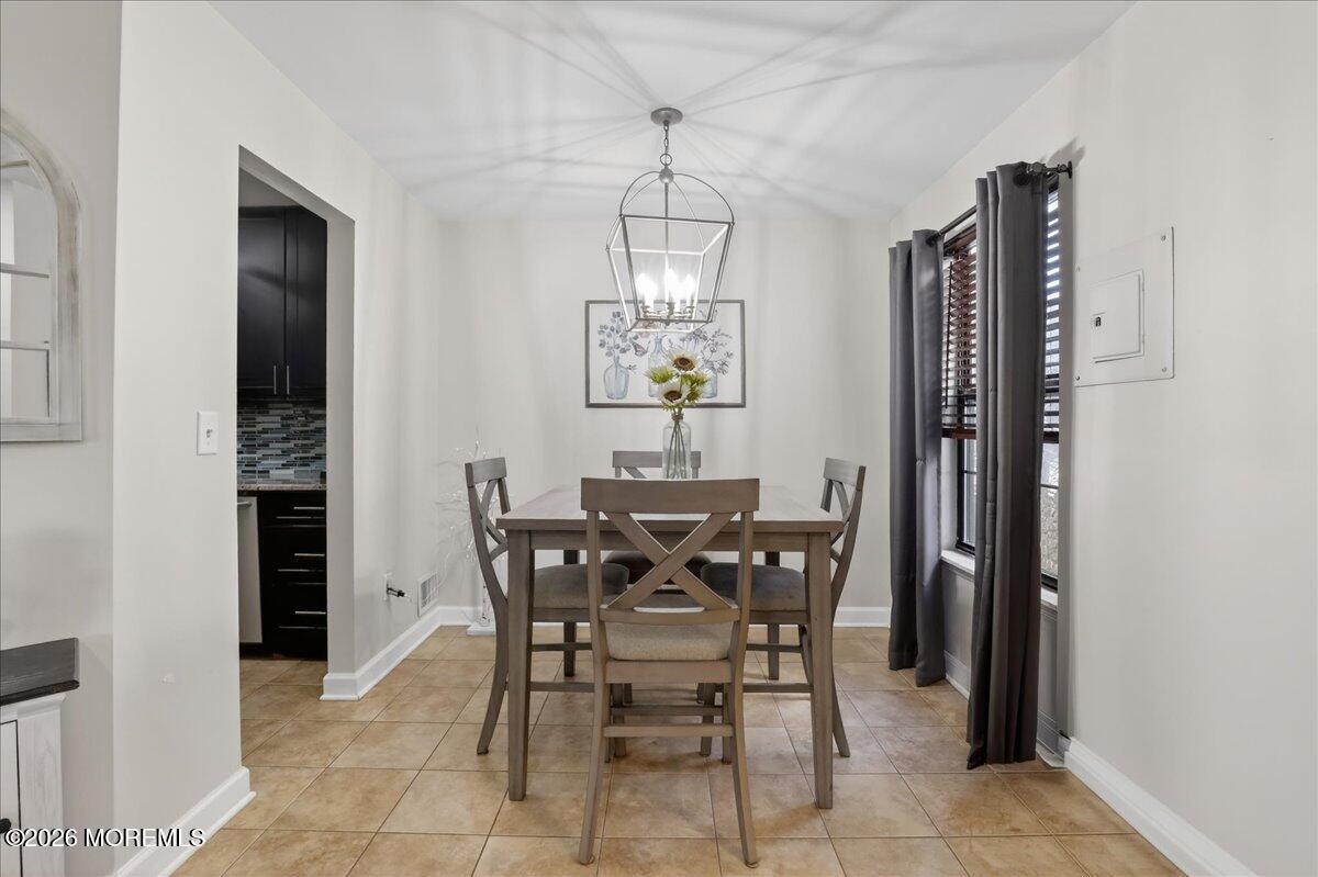 402 Daisy Court Jackson, NJ 08527 - Photo 9 of 44 a view of a dining room with furniture and window