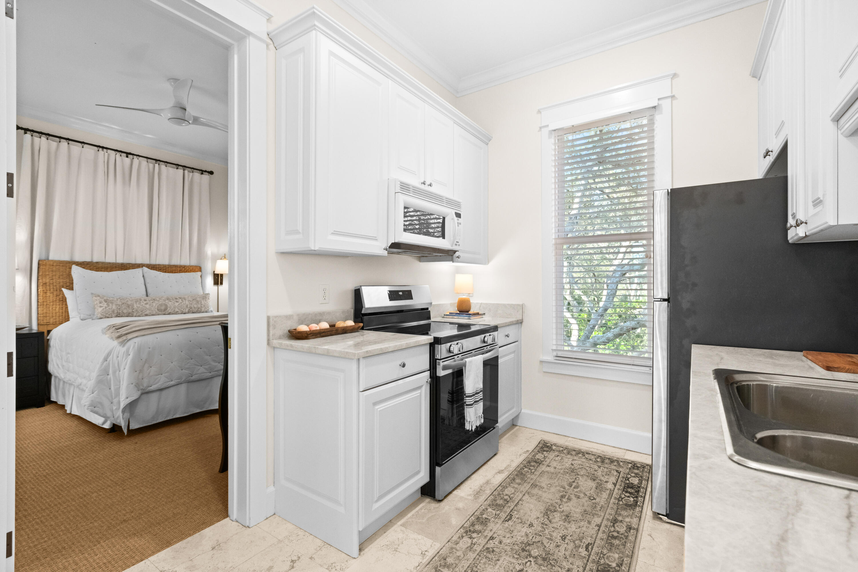 89 Sienna Court Santa Rosa Beach, FL 32459 - Photo 38 of 65 a kitchen with stainless steel appliances granite countertop a stove a sink and a microwave