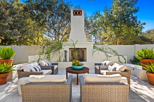 a view of a backyard with couches and a table and chairs