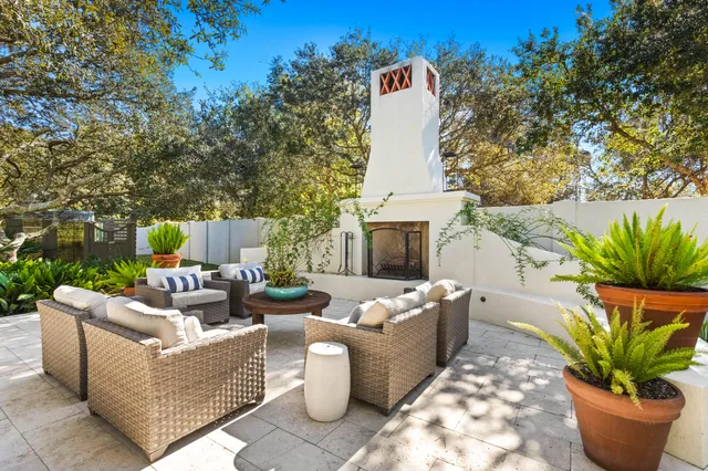 a view of house with swimming pool and tall trees