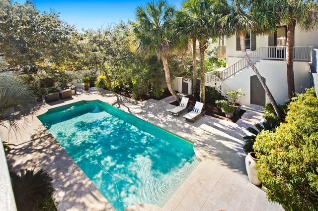 an aerial view of a house with a garden and trees