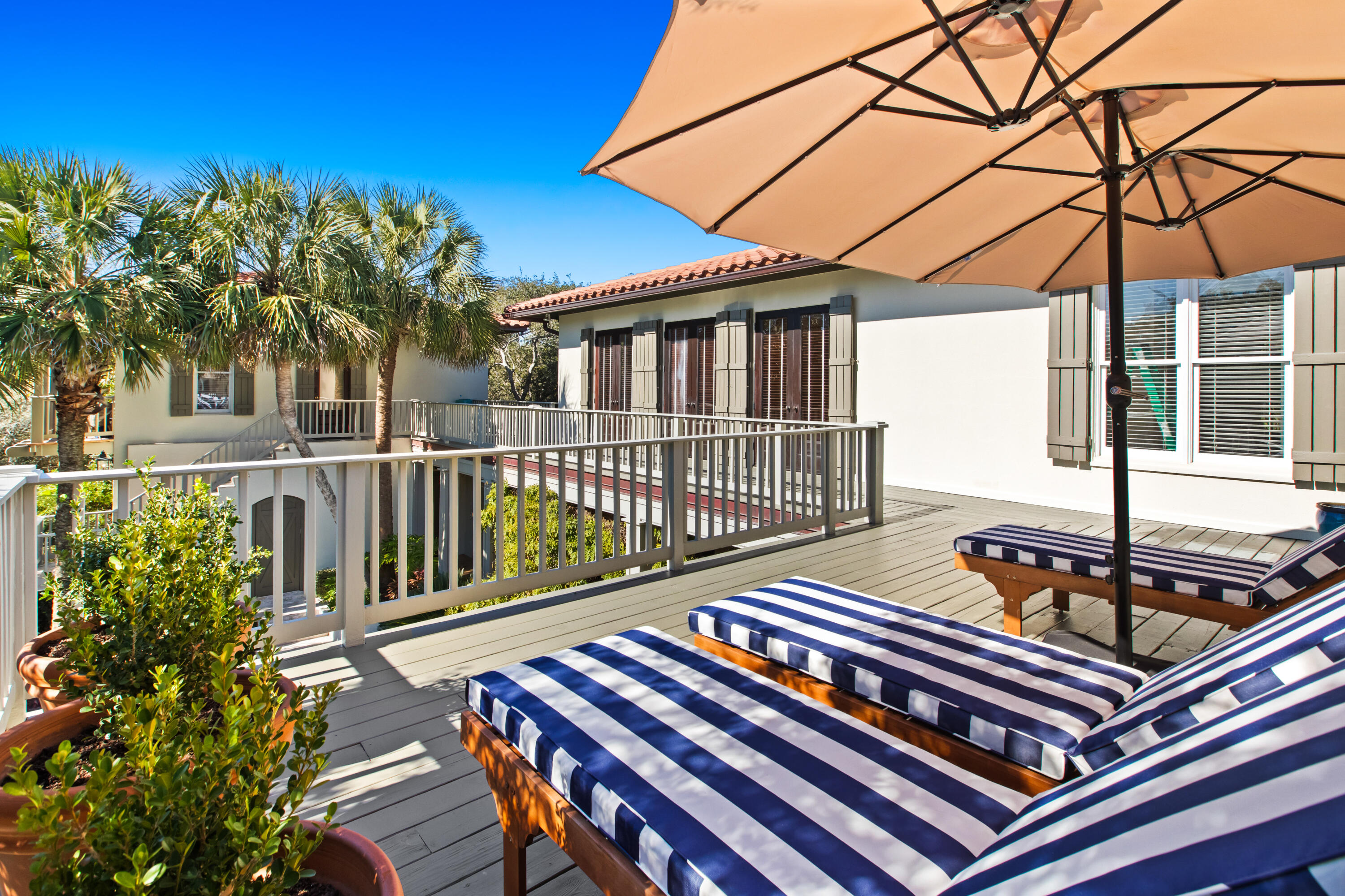 89 Sienna Court Santa Rosa Beach, FL 32459 - Photo 56 of 65 a view of a roof deck with table and chairs under an umbrella