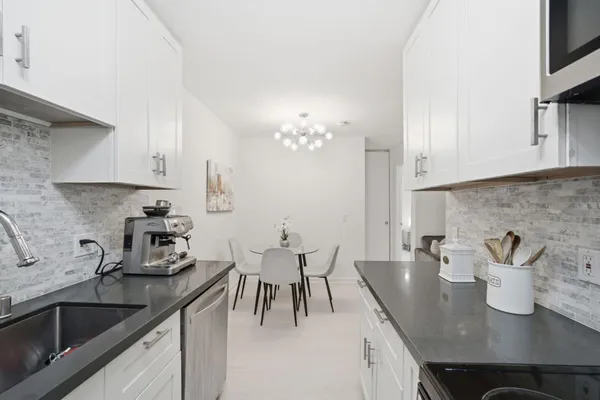 a kitchen with a sink cabinets and window