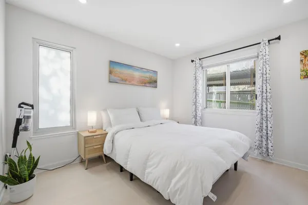 a bedroom with a bed and a window