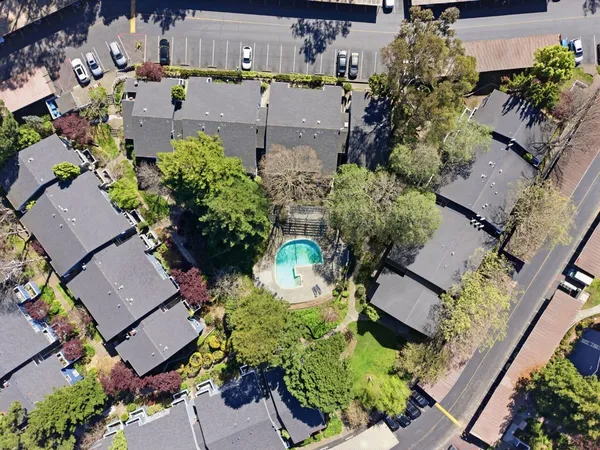 an aerial view of a house with a yard and lake view