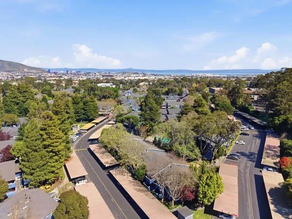 an aerial view of a residential houses with outdoor space