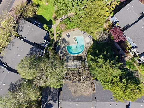 an aerial view of a house with garden space and street view