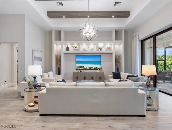 a living room with furniture and a chandelier