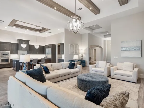 a living room with furniture and a chandelier