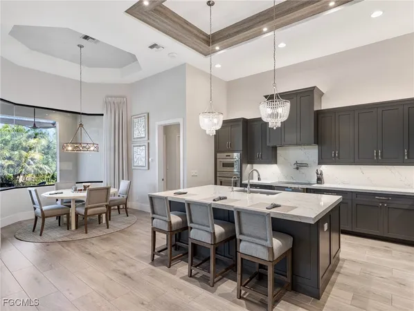 a large kitchen with a table and chairs