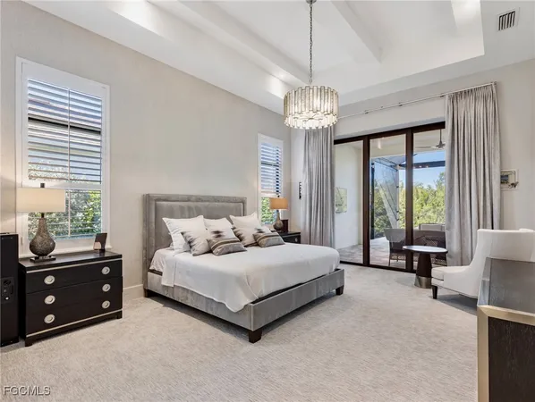 a spacious bedroom with a bed and a large window