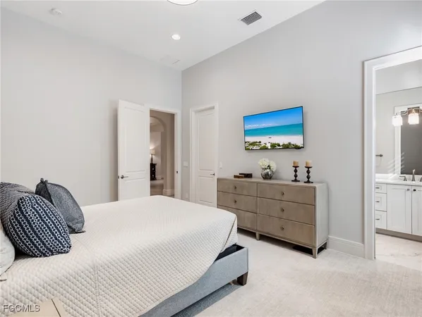 a bedroom with a bed and a dresser