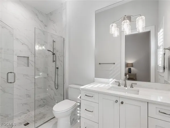 a bathroom with a toilet sink and shower