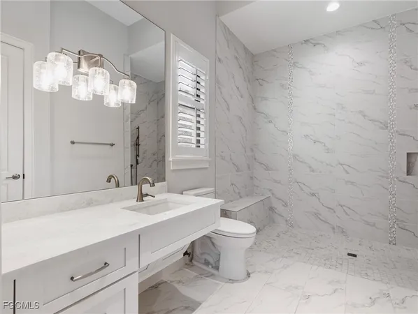 a bathroom with a sink a toilet and a mirror