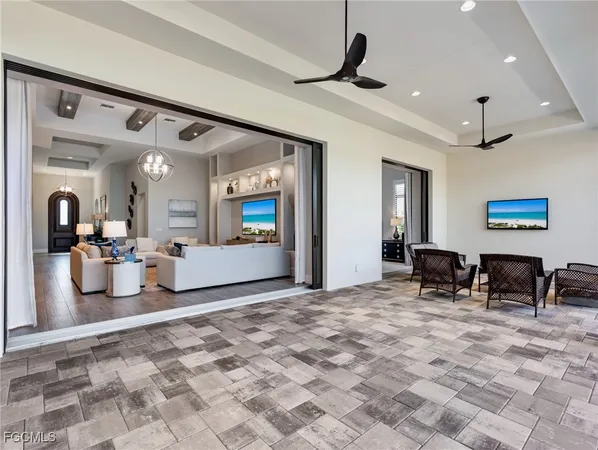 a view of a livingroom with furniture and a ceiling fan