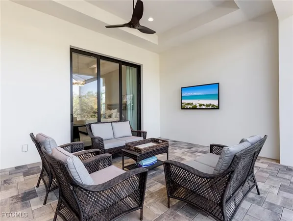 a living room with furniture and a floor to ceiling window