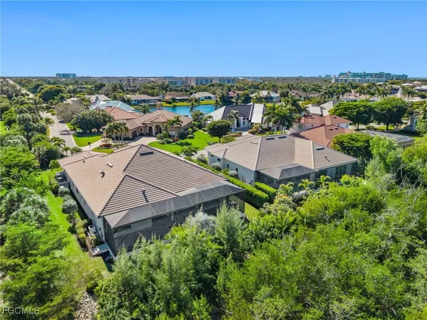 an aerial view of a house with a yard and lake view