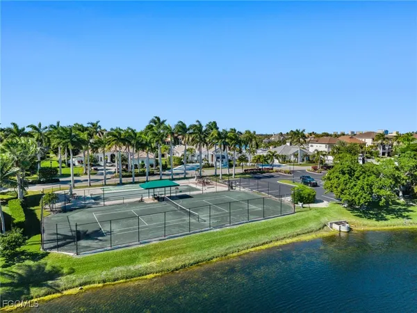 a view of a swimming pool with lawn chairs under an umbrella