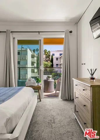 a bedroom with a bed and large window