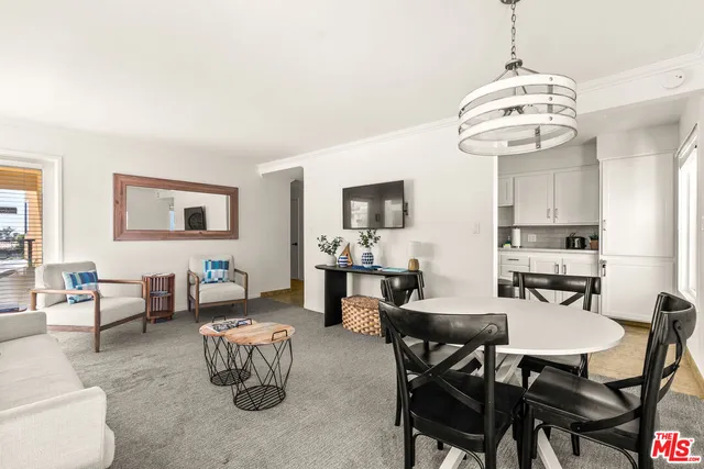 a view of a dining room with furniture and chandelier