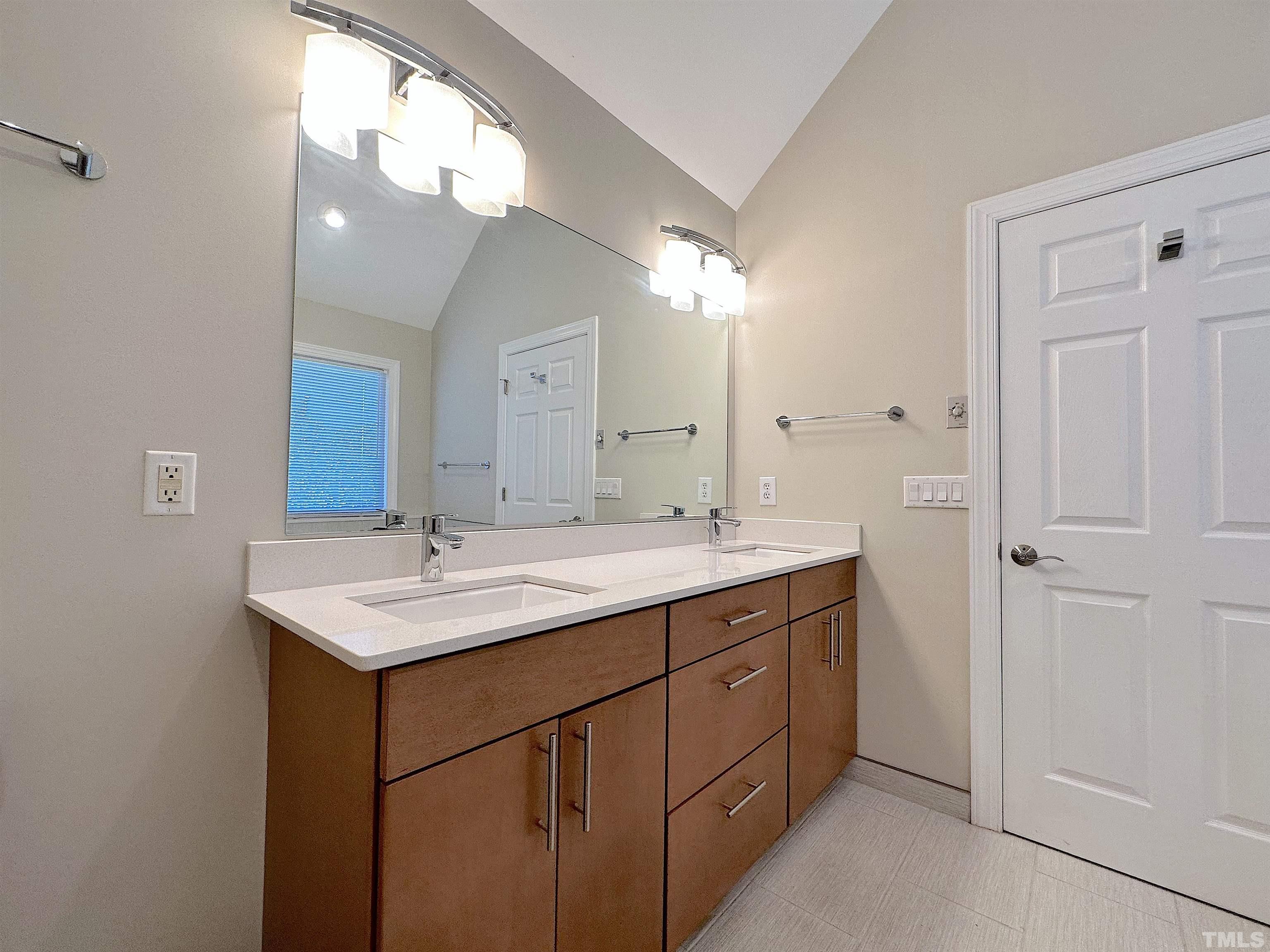 105 Wagon Trail Drive Cary, NC 27513 - Photo 13 of 22 a bathroom with a sink and a mirror