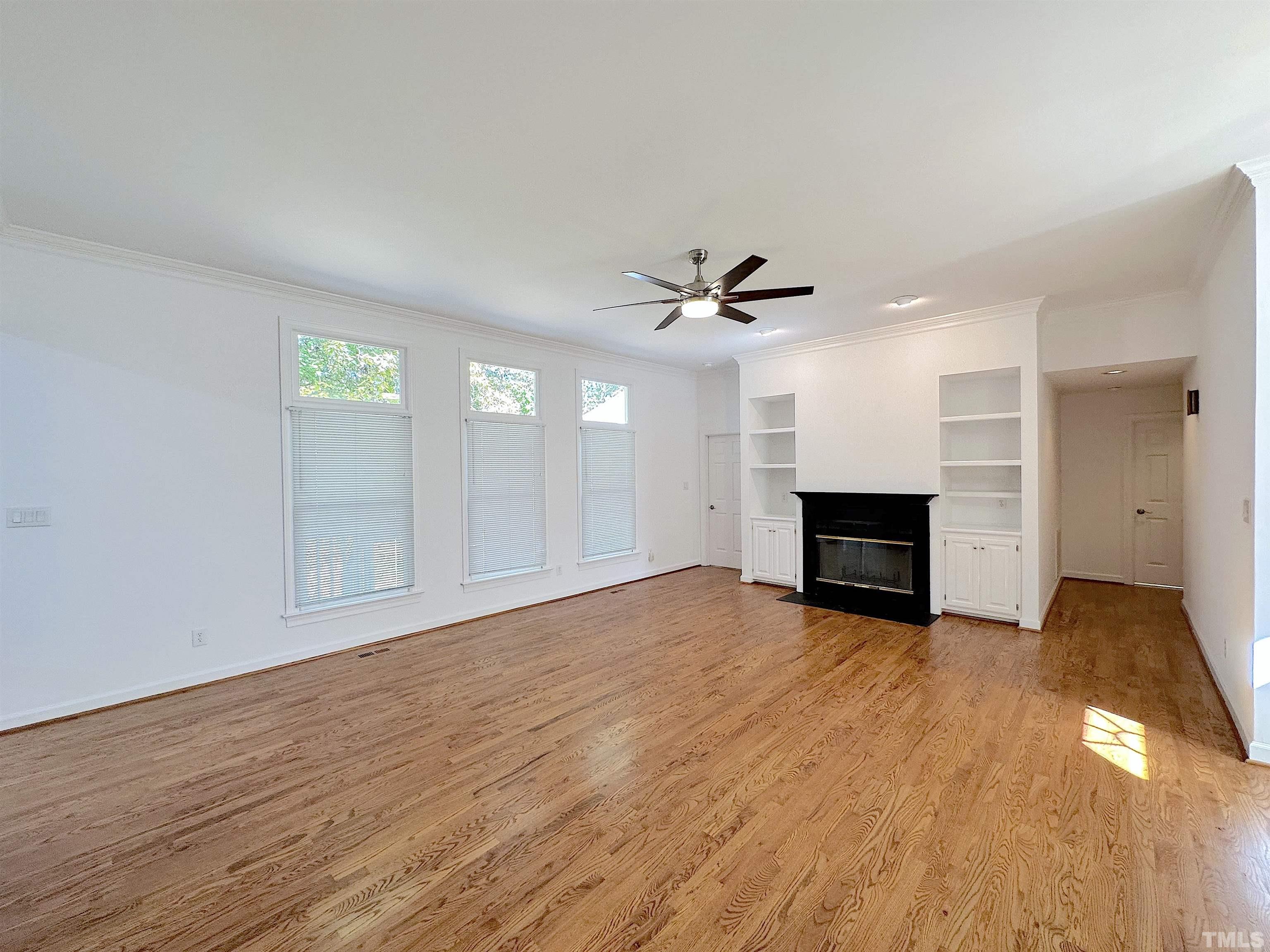 105 Wagon Trail Drive Cary, NC 27513 - Photo 3 of 22 a view of empty room with wooden floor and fireplace