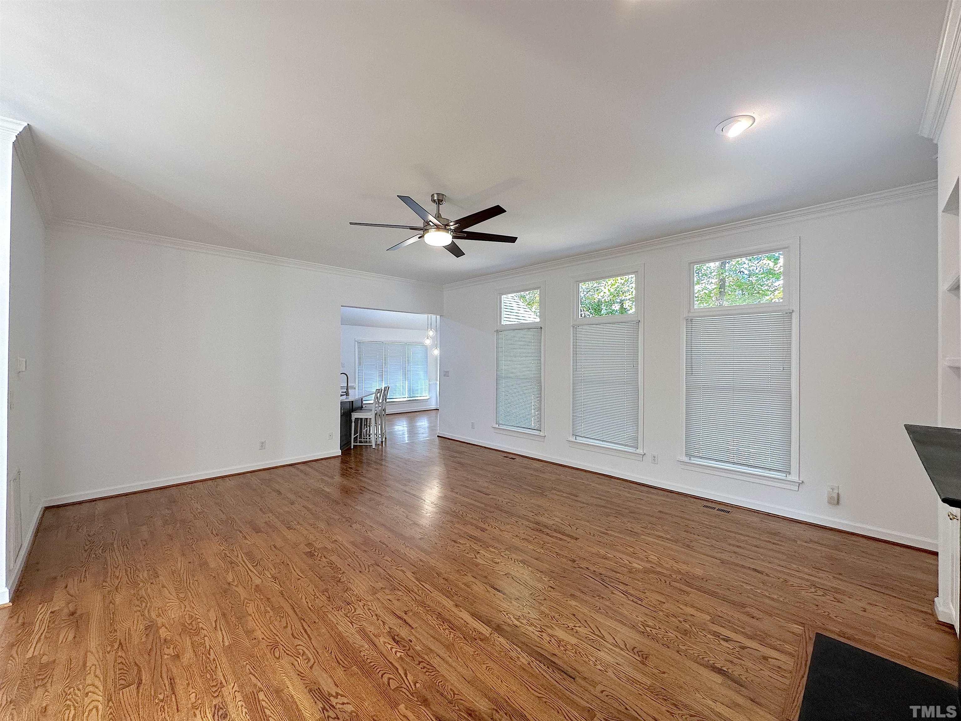 105 Wagon Trail Drive Cary, NC 27513 - Photo 4 of 22 a view of empty room with wooden floor and fan