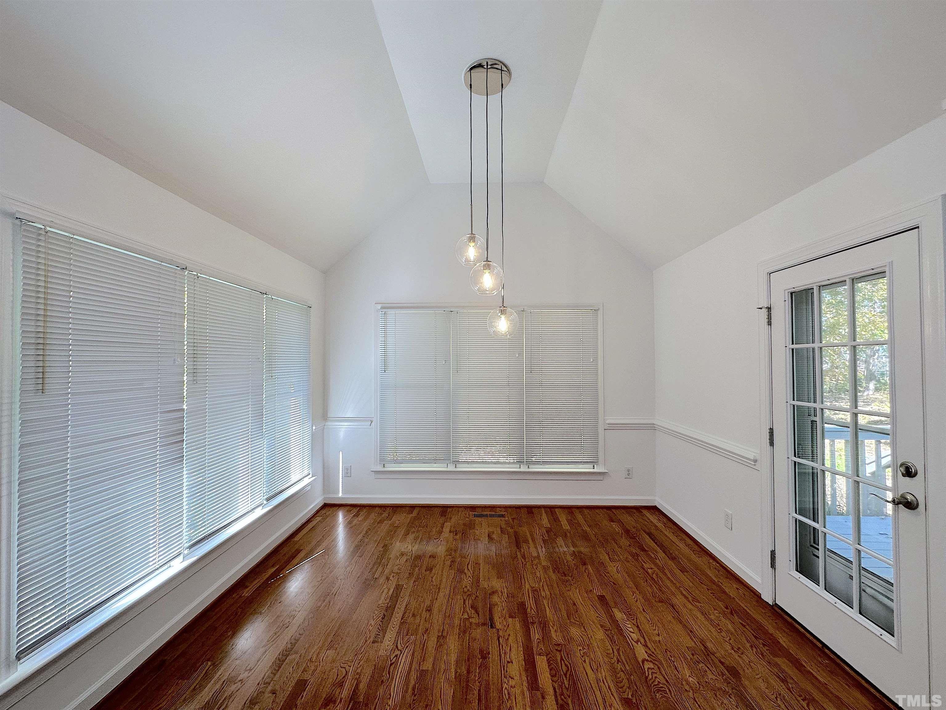 105 Wagon Trail Drive Cary, NC 27513 - Photo 6 of 22 a view of empty room with wooden floor and fan