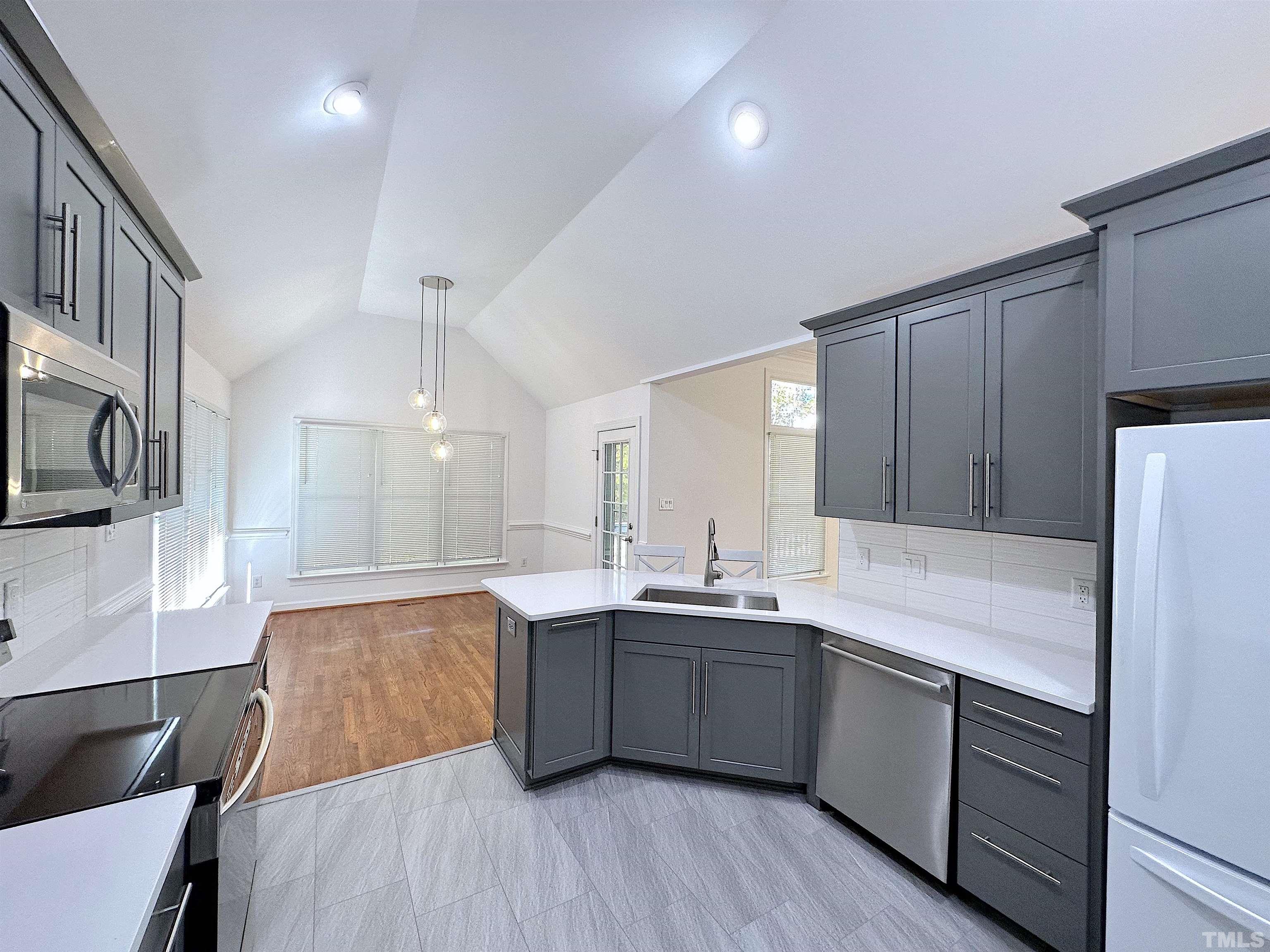 105 Wagon Trail Drive Cary, NC 27513 - Photo 9 of 22 a kitchen with white cabinets and sink