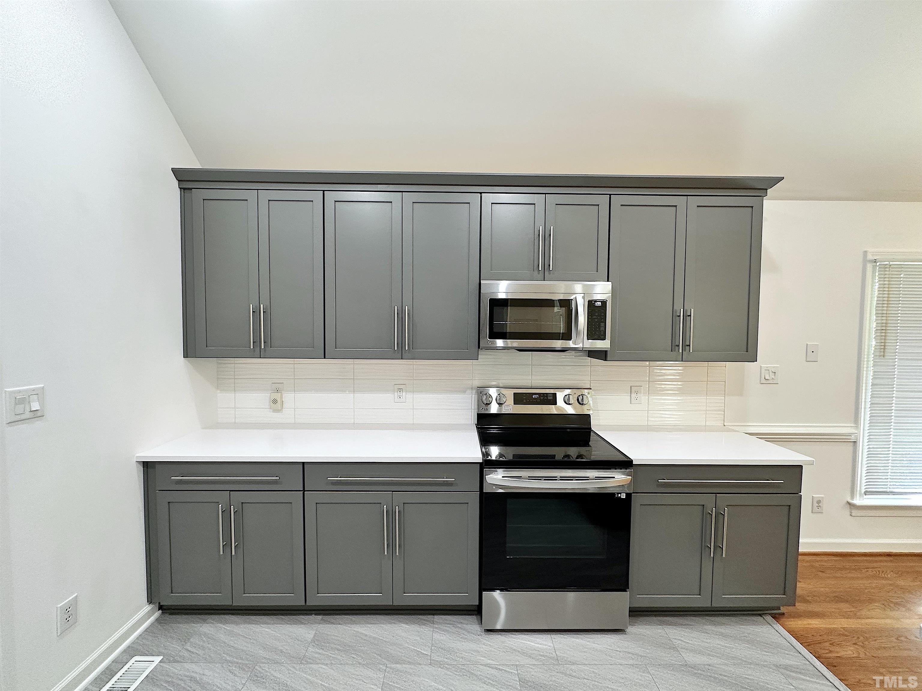 105 Wagon Trail Drive Cary, NC 27513 - Photo 10 of 22 a kitchen with wooden cabinets and a stove top oven
