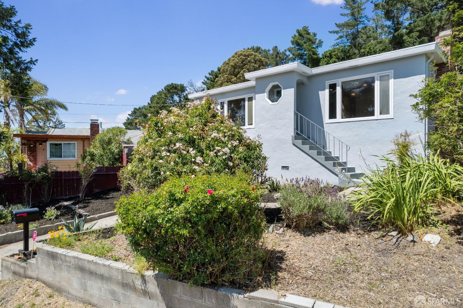 a front view of house with yard and trees around