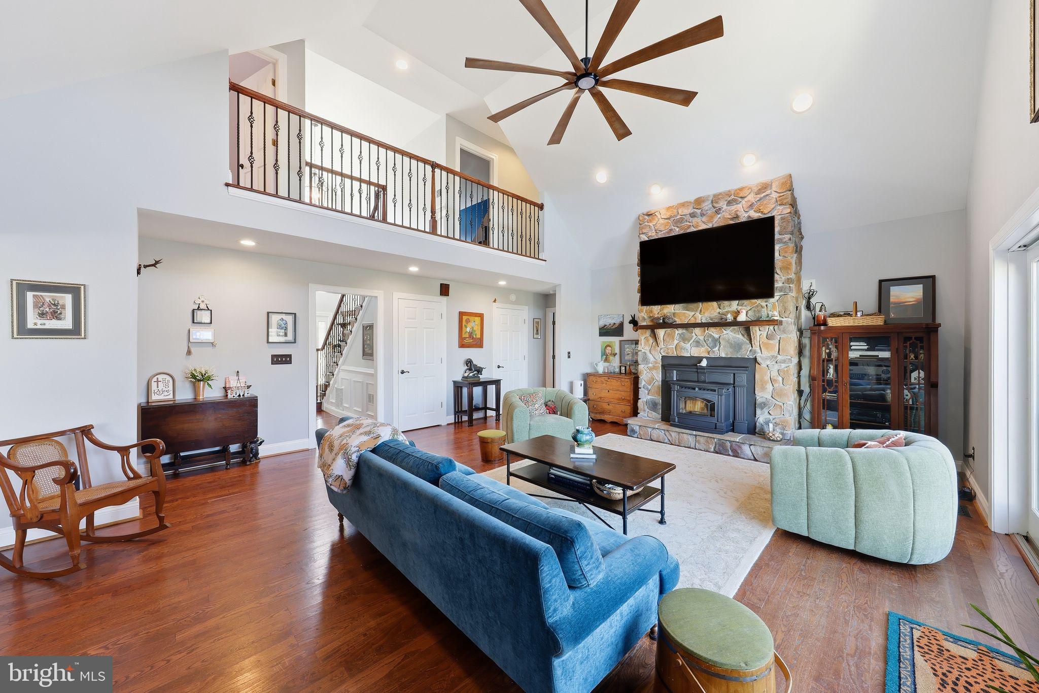 121 Little Eagle Road Centreville, MD 21617 - Photo 11 of 64 a living room with furniture a flat screen tv and a fireplace