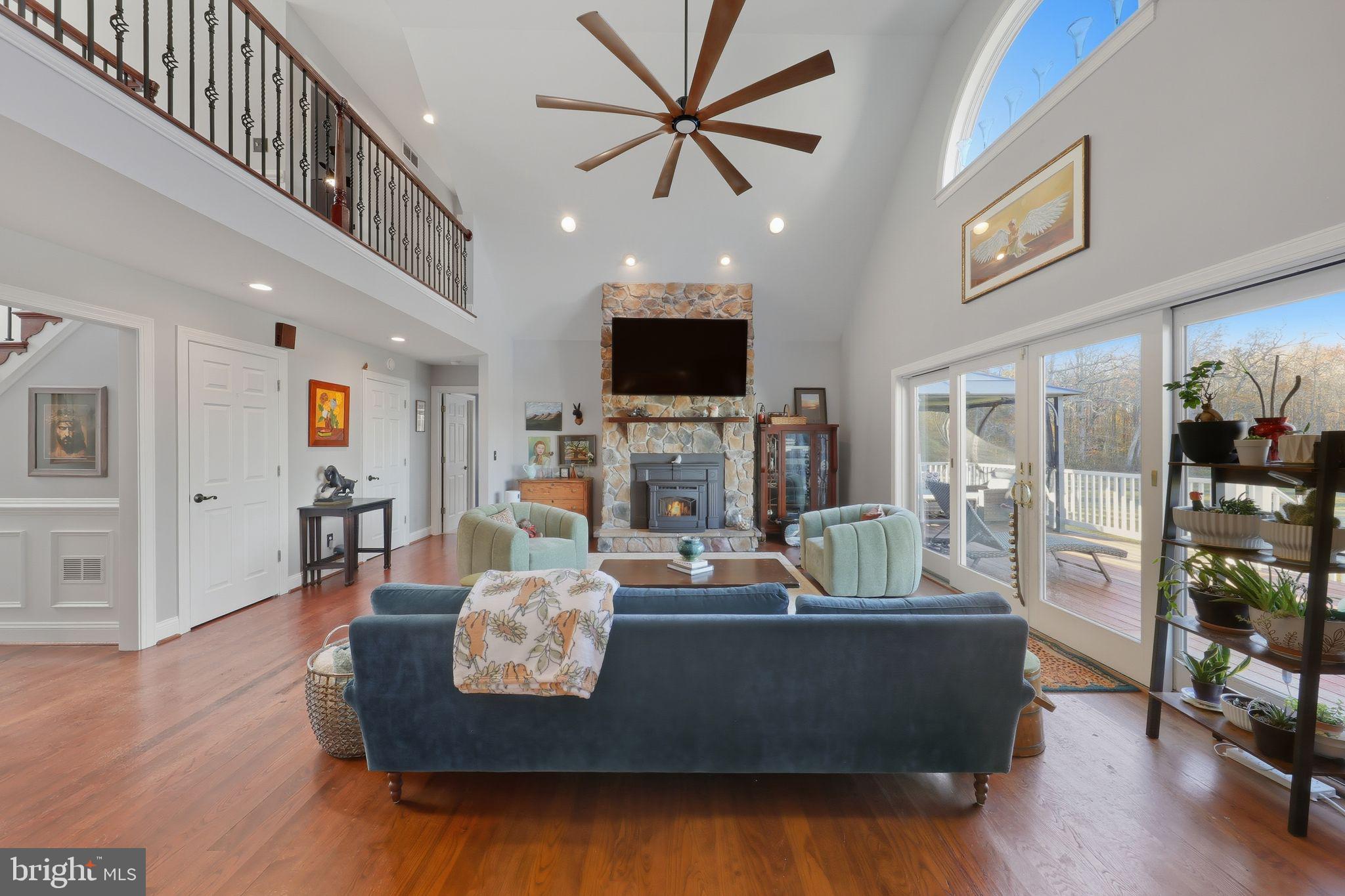 121 Little Eagle Road Centreville, MD 21617 - Photo 12 of 64 a living room with fireplace furniture and a flat screen tv