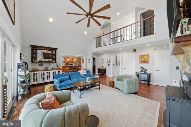 a living room with furniture a flat screen tv and kitchen view
