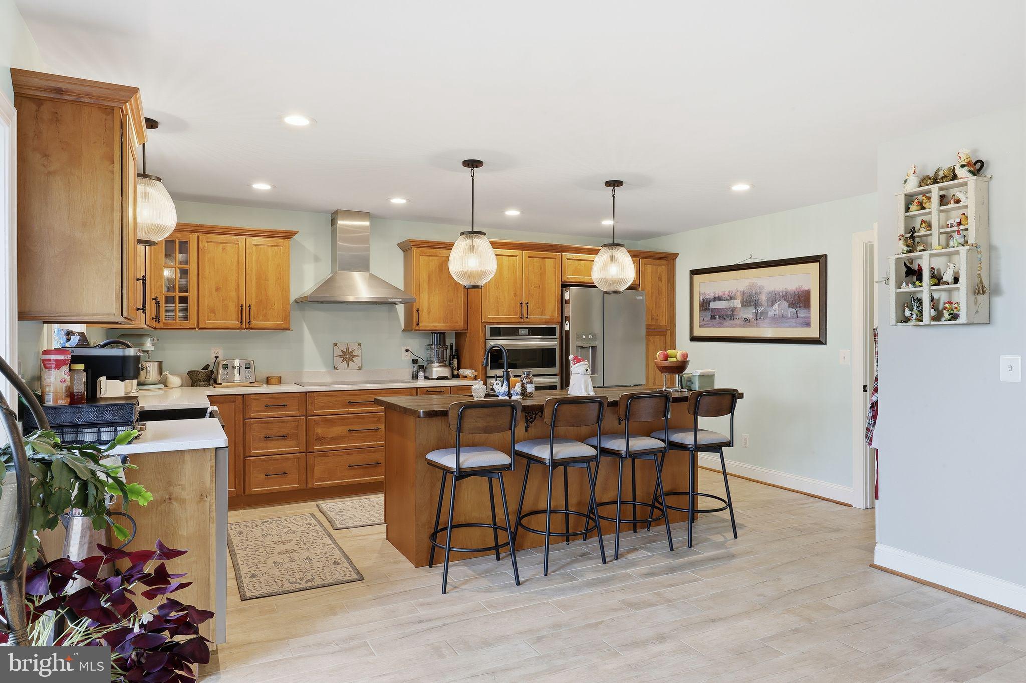 121 Little Eagle Road Centreville, MD 21617 - Photo 18 of 64 a kitchen with stainless steel appliances kitchen island granite countertop a sink a stove a dining table and chairs