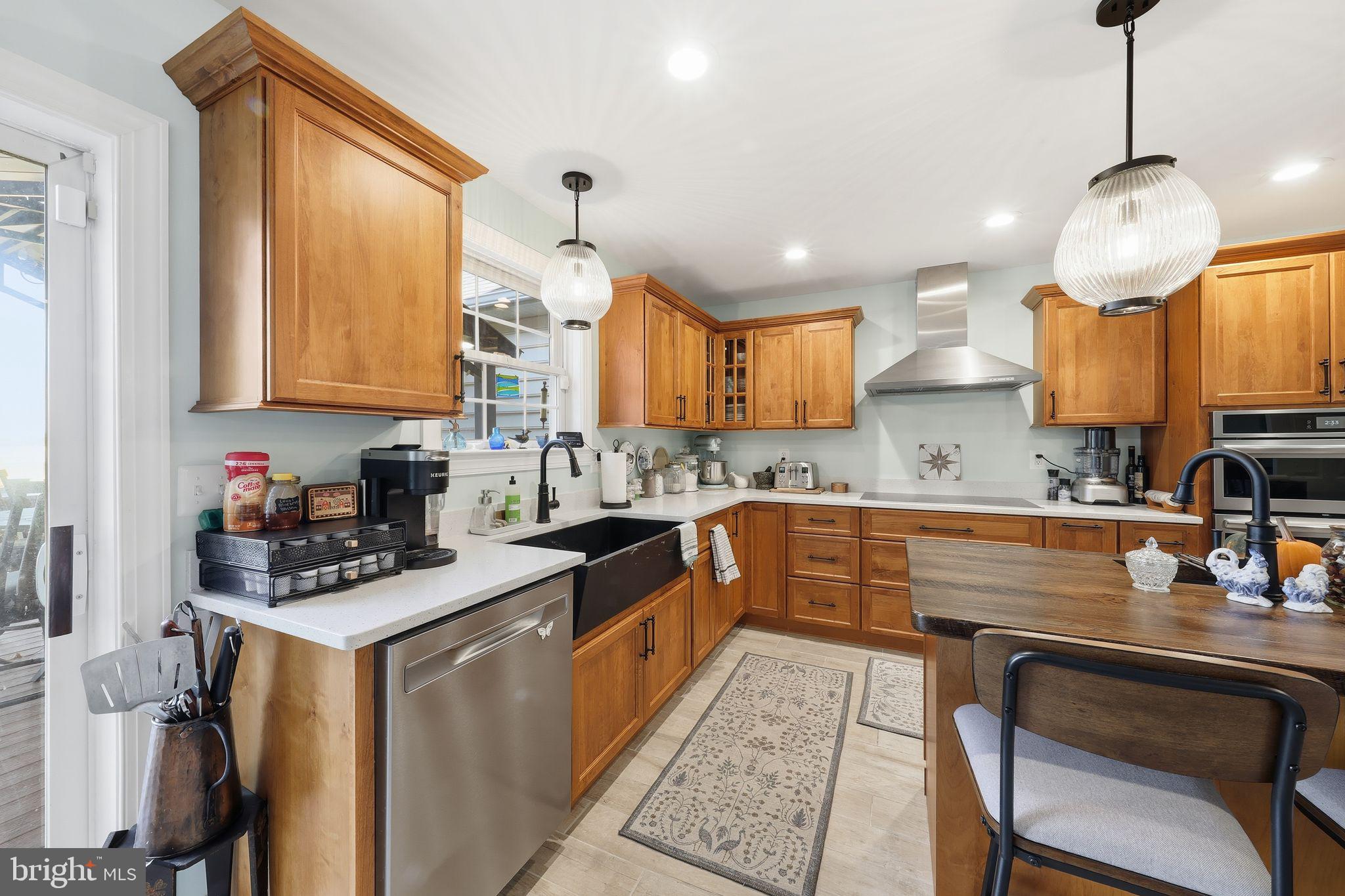 121 Little Eagle Road Centreville, MD 21617 - Photo 25 of 64 a kitchen with granite countertop a stove a sink a counter space and cabinets