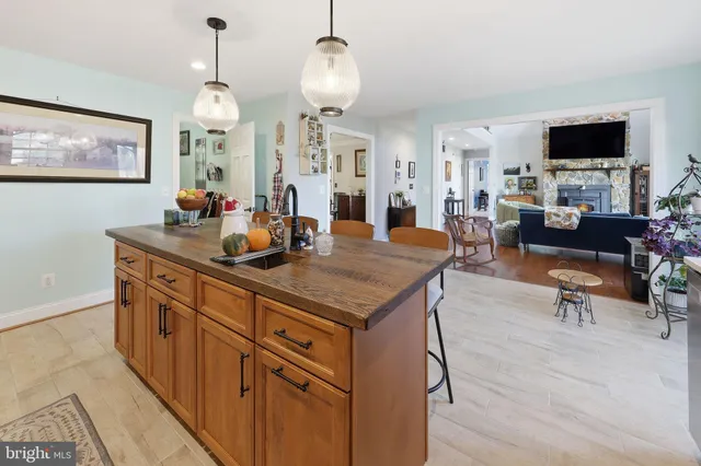 a living room with furniture pool table and a large window