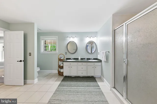 a living room with furniture a rug and a book shelf