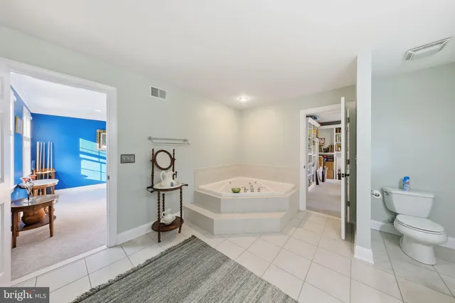 a bedroom with a bed dresser and a window