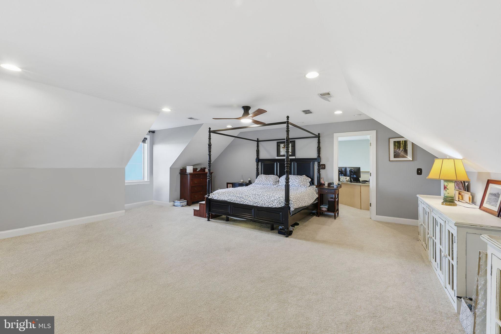 121 Little Eagle Road Centreville, MD 21617 - Photo 39 of 64 a bedroom with furniture and a chandelier