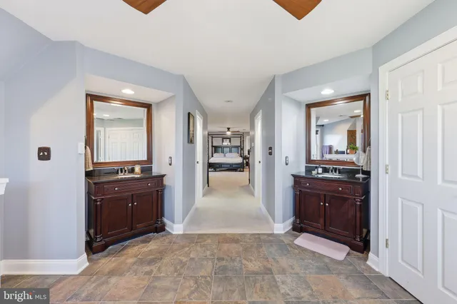 a bathroom with a sink a toilet and a mirror
